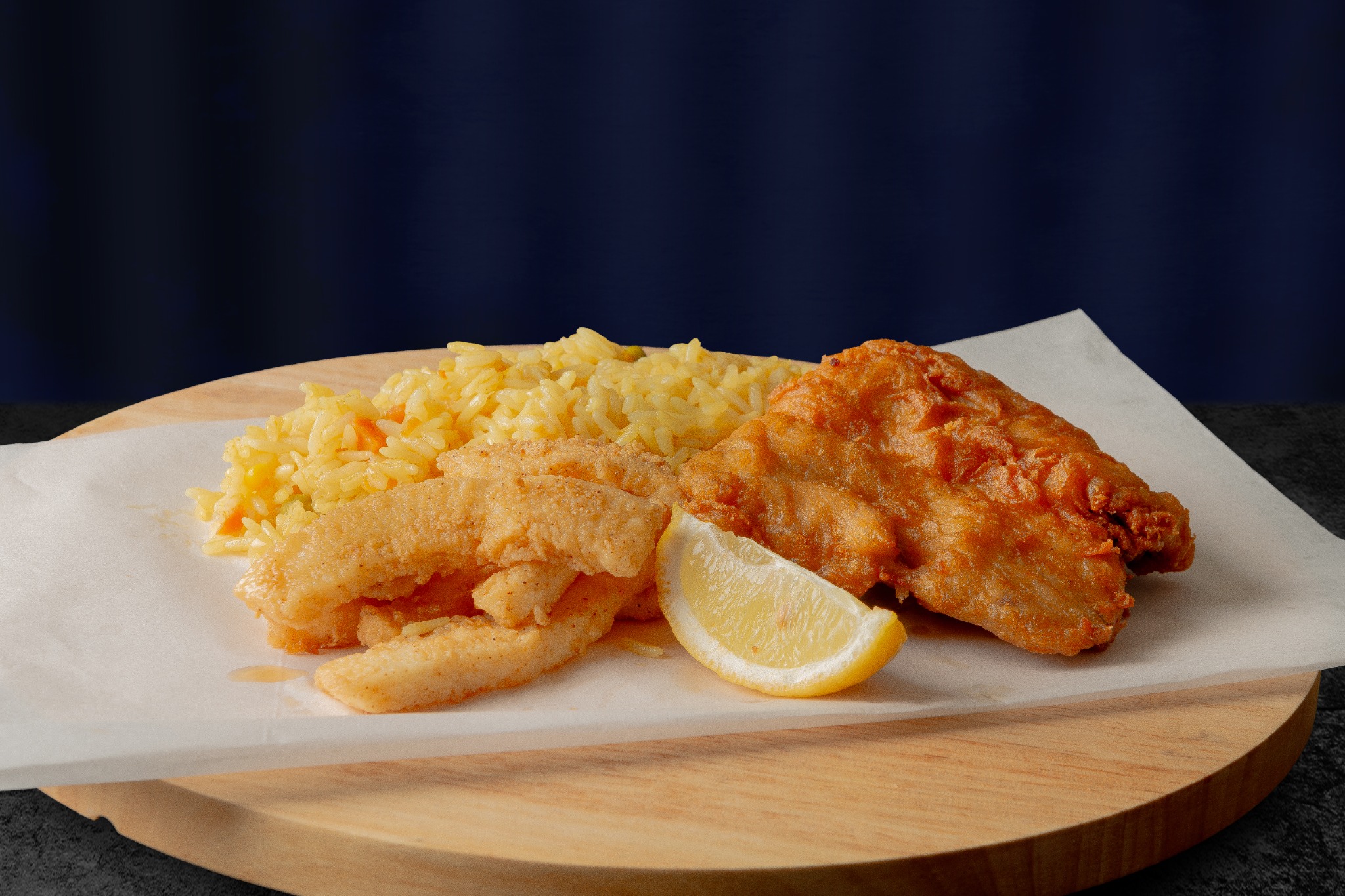 Fish and calamari served with rice and lemon at Fishermans Choice